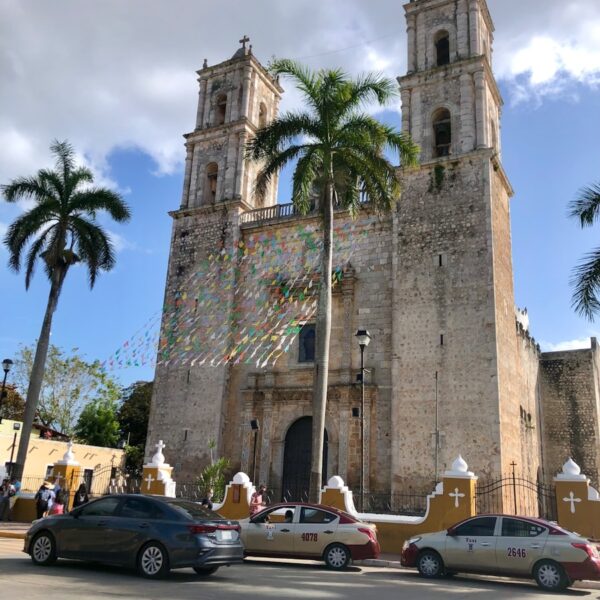 a large church with a tall tower with a clock on it's side